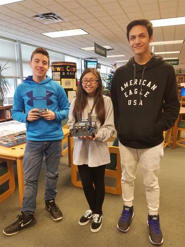 High School Students show off their XEX IQ Robot they put together in the MS/HS Lbrary